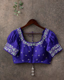 Green Checkered Gadwal Pattu saree with a contrast dark blue puff sleeves blouse