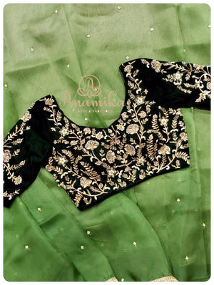 Luxurious and a royal appearance in this shaded green organza saree