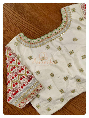 Off white blouse with heavy zardosi work and red threadwork