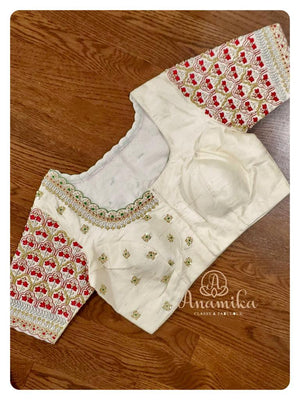 Off white blouse with heavy zardosi work and red threadwork