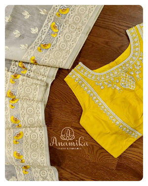 Off white organza saree with a sleeveless yellow blouse