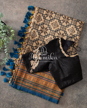 Tussar silk saree paired with a beautiful contrast black blouse
