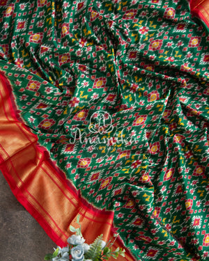 Dark Green Ikkat Patola saree with contrast off white blouse