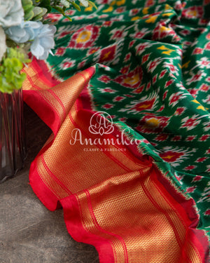 Dark Green Ikkat Patola saree with contrast off white blouse