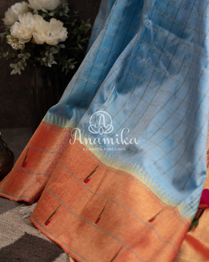 Pastel Blue Pure Paithani saree with triple muniya border and a beautiful parrots pallu