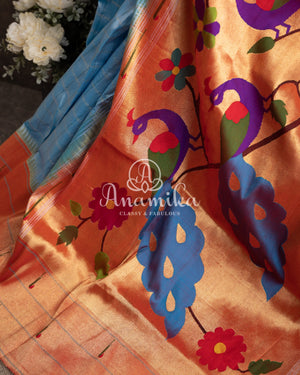 Pastel Blue Pure Paithani saree with triple muniya border and a beautiful parrots pallu