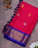 Reddish Pink Checkered Gadwal Pattu saree with a contrast dark blue puff sleeves blouse