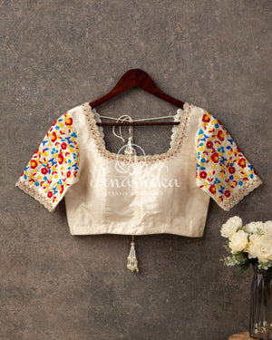 Off white blouse with silver zardosi and all over multi color thread work on sleeves