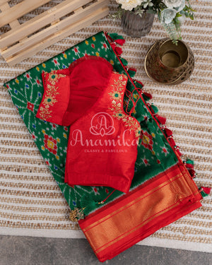 Dark Green Ikkat Patola saree with kanchi border - and a contemporary puff sleeves blouse