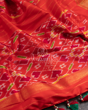 Dark Green Ikkat Patola saree with kanchi border - and a contemporary puff sleeves blouse