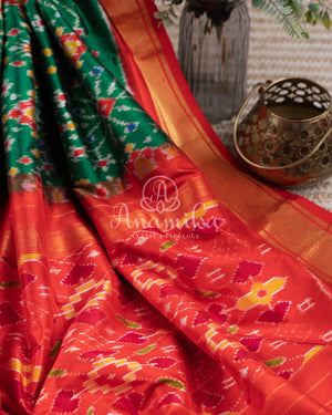 Dark Green Ikkat Patola saree with kanchi border - and a contemporary puff sleeves blouse