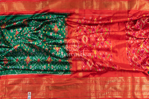 Dark Green Ikkat Patola saree with kanchi border - and a contemporary puff sleeves blouse