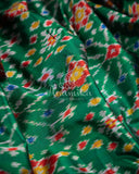 Dark Green Ikkat Patola saree with kanchi border - and a contemporary puff sleeves blouse
