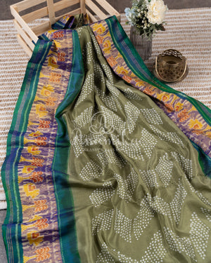 Pure silk bandini saree in shades of green/turquoise with a patola border and pallu