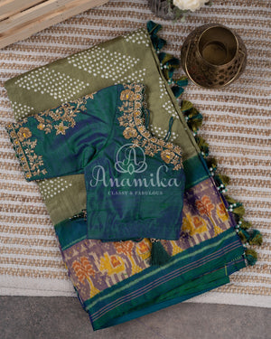 Pure silk bandini saree in shades of green/turquoise with a patola border and pallu