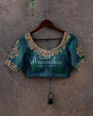 Pure silk bandini saree in shades of green/turquoise with a patola border and pallu