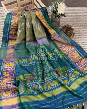Pure silk bandini saree in shades of green/turquoise with a patola border and pallu