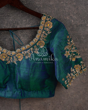 Pure silk bandini saree in shades of green/turquoise with a patola border and pallu