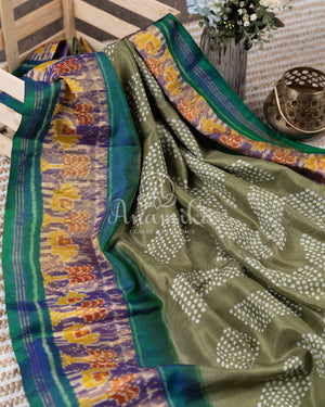 Pure silk bandini saree in shades of green/turquoise with a patola border and pallu