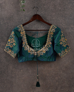 Pure silk bandini saree in shades of green/turquoise with a patola border and pallu