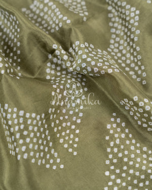 Pure silk bandini saree in shades of green/turquoise with a patola border and pallu