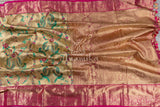 A pure kanjeevaram tissue saree with a contrast tomato pink color heavy work blouse