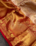 A pure kanjeevaram tissue saree with a contrast maroonish red color heavy work blouse
