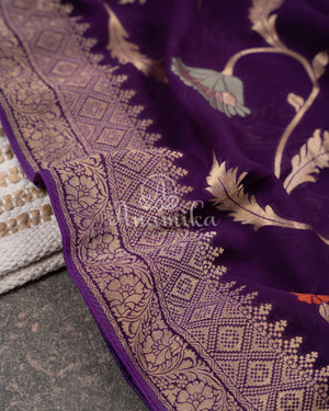 Purple Banarasi georgette saree with floral jaal design paired with contrast pink blouse