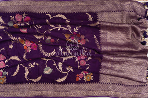 Purple Banarasi georgette saree with floral jaal design paired with contrast pink blouse