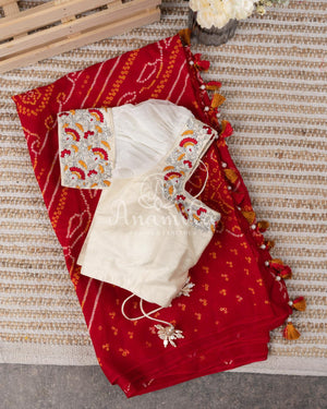 Red Crepe Bandini saree with contrast off white puff sleeves blouse