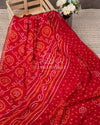 Red Crepe Bandini saree with contrast off white puff sleeves blouse