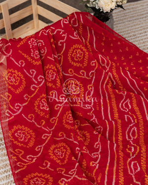 Red Crepe Bandini saree with contrast off white puff sleeves blouse