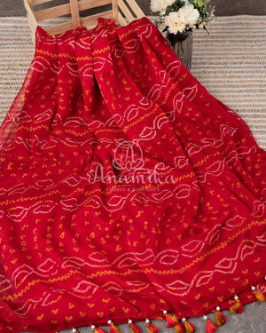 Red Crepe Bandini saree with contrast off white puff sleeves blouse