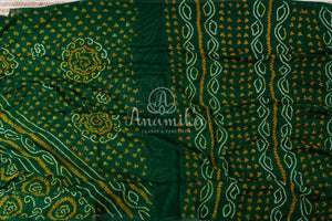 Dark Green Bandini Crepe saree with a contrast yellow blouse