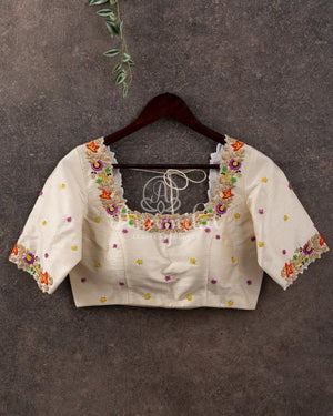 Off white blouse with beautifully designed multi color thread embroidery