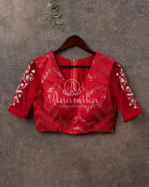 A contemporary styled Red Sequins Blouse with net sleeves & embroidery