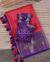 Reddish Pink Kanchipattu saree with a contrast purple blouse