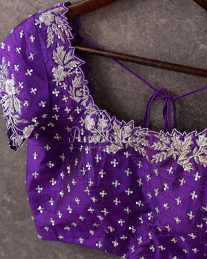 Reddish Pink Kanchipattu saree with a contrast purple blouse