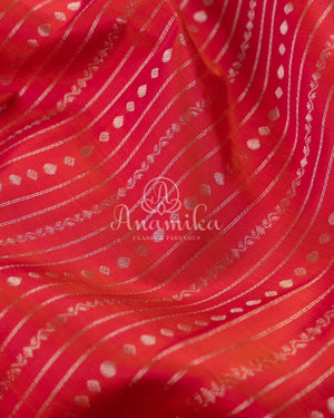 Reddish Pink Kanchipattu saree with a contrast purple blouse
