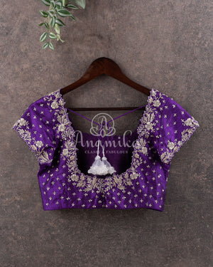 Reddish Pink Kanchipattu saree with a contrast purple blouse