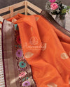 Orange Banarasi Kora Saree with meenakari floral border paired with a contrast brown blouse