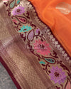 Orange Banarasi Kora Saree with meenakari floral border paired with a contrast brown blouse
