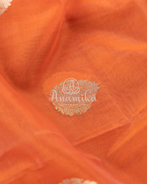 Orange Banarasi Kora Saree with meenakari floral border paired with a contrast brown blouse
