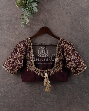 Orange Banarasi Kora Saree with meenakari floral border paired with a contrast brown blouse