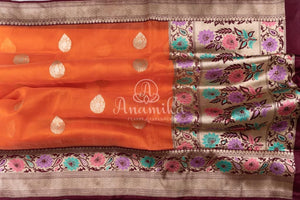 Orange Banarasi Kora Saree with meenakari floral border paired with a contrast brown blouse