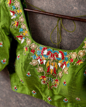 Red Tusser Georgette saree with all over floral jaal, paired with a contrast green blouse