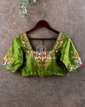 Red Tusser Georgette saree with all over floral jaal, paired with a contrast green blouse