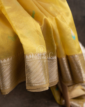 Yellow Chanderi pattu saree with a contrast blue blouse