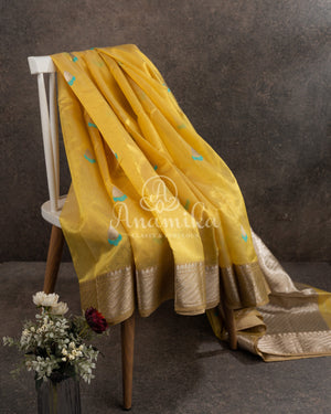 Yellow Chanderi pattu saree with a contrast blue blouse