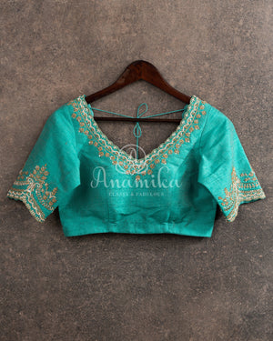 Yellow Chanderi pattu saree with a contrast blue blouse